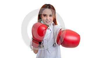 Young Asian female doctor punch with boxing glove.