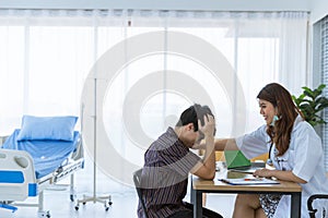 Young Asian female doctor is smiling and touching patient`s sholder in hospital room. Medical healtcare concept photo