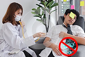 Young Asian female doctor with stethoscope diagnosing disabled business man