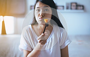 Young asian female eating fresh fruits papaya slices,Concept healthy food