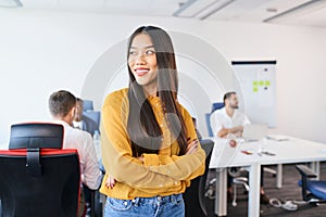 Young Asian female entrepreneur standing at coworking office.