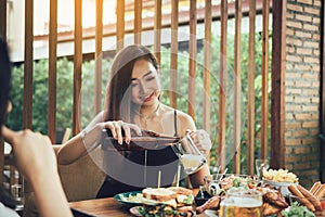 Young asian female having fun at drinking with cheering with beer at restaurant