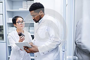 Medical assistant asking doctor about pills photo