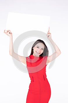 Young asian female showing blank sign card cheerful and happy smiling - copy space for text. Beautiful smiling young woman model