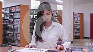 Young Asian female university students are working mathematics homework