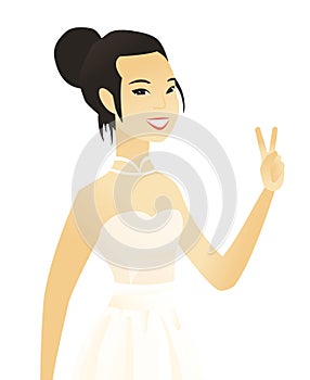 Young asian fiancee showing the victory gesture.