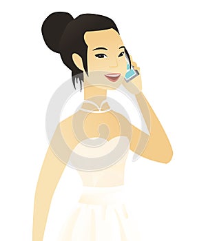 Young asian fiancee talking on a mobile phone.