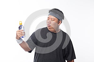 Young Asian funny fat sport man holding water bottle isolated on white background.
