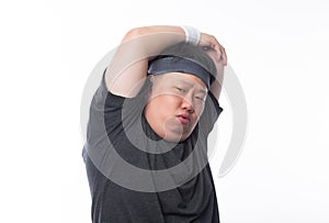 Young Asian funny fat sport man stretching before exercise isolated on white background.