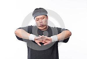 Young Asian funny fat sport man stretching before exercise isolated on white background.