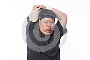 Young Asian funny fat sport man stretching before exercise isolated on white background.