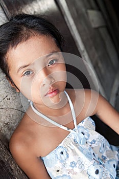 Young Asian girl against wall