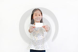 Young Asian girl child showing white card against white background. Focus at card in her hands