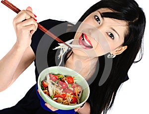 Young asian girl eating salad