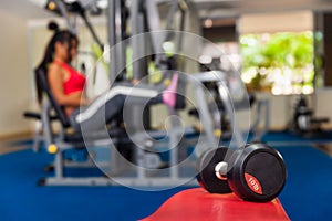 Young Asian girl exercising in the gym to strengthen muscle mass and body slimming