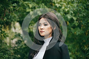 Young asian girl in front of the autumn trees