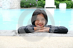 Young Asian girl having fun at swiming pool