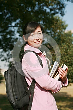 Young asian girl holding books