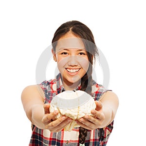 Young Asian girl holds cerebrum model in her hand