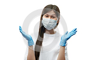 Young asian girl in medical mask and blue gloves amazedly shrug