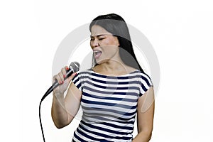 Young asian girl is performing a song in microphone heartily.