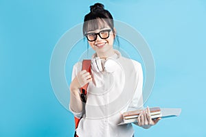 Young asian girl is practicing guitar at home and composing music