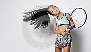 Young asian girl preteen big tennis player studio shot