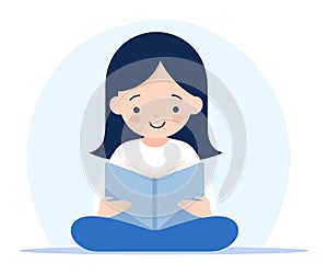 Young Asian girl sitting cross-legged reading a book with a happy expression. Peaceful reading time and love for books