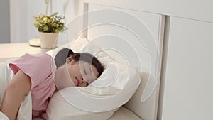 Young Asian girl sleeping at home. Asia japanese woman child kid relax rest asleep lying on bed, feel comfort and calm in bedroom