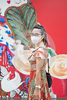 Young Asian girl wearing Protective face mask protect coronavirus inflection, Happy tourist woman in New Normal lifestyle after