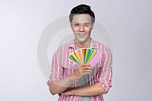 Young asian graphic designer holding color palette