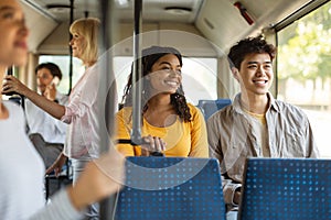 Young asian guy and black lady taking bus together