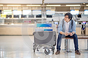 Young asian guy waiting for airport check in