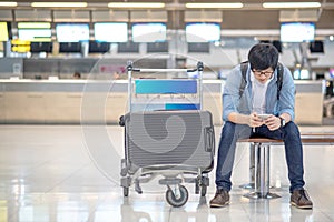 Young asian guy waiting for airport check in