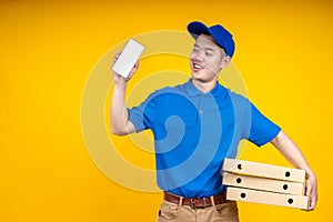 Young Asian handsome delivery man holding box on left arm and showing application on mobile