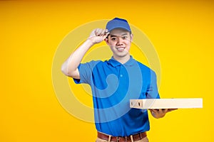 Young Asian handsome delivery man holding a pizza box
