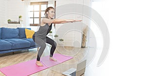 Young Asian healthy woman in sportswear doing fitness stretching exercises at home in the living room. home sport and recreation