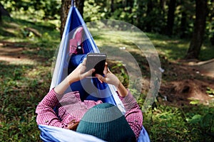 Young asian hiker woman using mobile phone while relaxing in ham