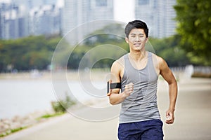 Young asian jogger running in park