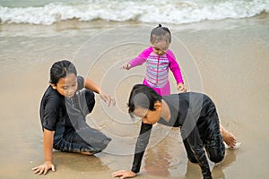 Young asian kids are playing on the beach. Vacation and relax concept