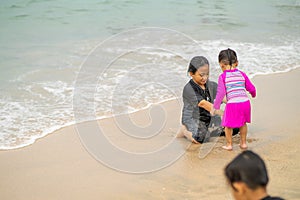 Young asian kids are playing on the beach. Vacation and relax concept