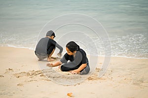 Young asian kids are playing on the beach. Vacation and relax concept