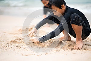 Young asian kids are playing on the beach. Vacation and relax concept