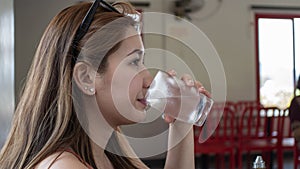 Young asian lady drinking fresh water