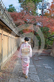 Young Asian Lady in Kimono walking in an empty Street in Higahiyama District, Gion, Kyoto, Japan