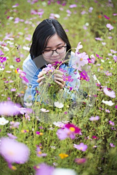 Young Asian lady smell flowers at meadows