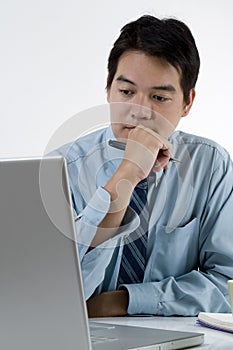 Young Asian male with computer