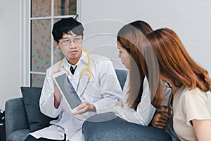 Young Asian male doctor consulting patient in hospital office. Health care and medical concept