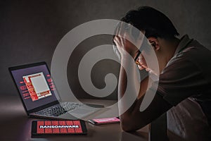 Young Asian male frustrated by WannaCry ransomware attack