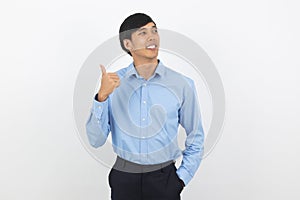 Young asian man with black shirt pointing to the side with a finger to present a product or an idea